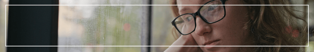 sad woman at window