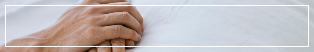 holding hands on hospital bed