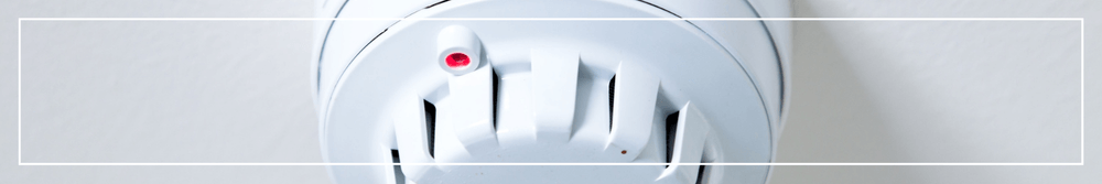 white smoke alarm on celling